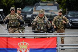 Italian members of the NATO-led Kosovo Force (KFOR) stand guard in Leposavic [Ognen Teofilovski/Reuters]
