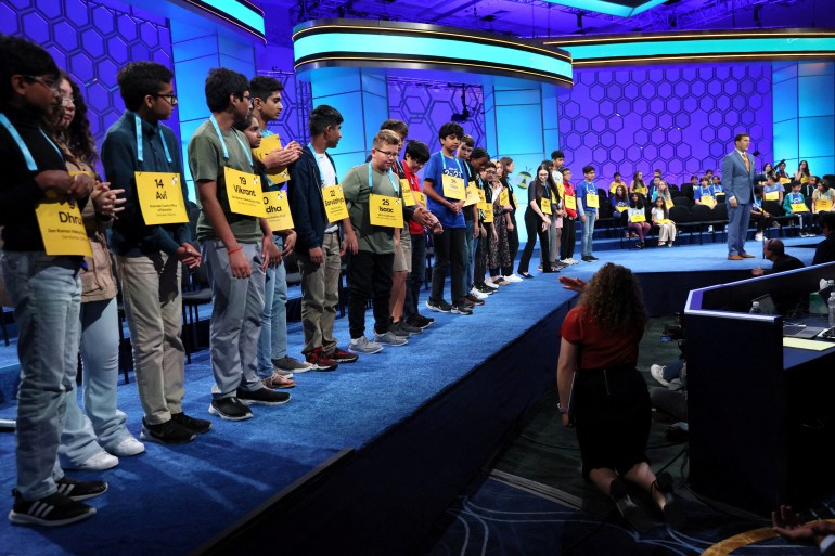 Competitors in US National Spelling Bee line up on stage