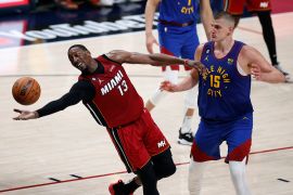 Miami Heat centre Bam Adebayo reaches for the ball as Denver Nuggets centre Nikola Jokic (15) looks on during the fourth quarter in game one of the 2023 NBA Finals at Ball Arena [Isaiah J Downing/USA TODAY Sports via Reuters]