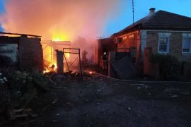 Firefighters work at a house on fire following a shelling, which, according to the regional governor, was by Ukrainian forces, in the village of Sobolevka, Belgorod region, Russia. [Handout: Governor of Russia’s Belgorod Region Vyacheslav Gladkov via Telegram via Reuters]