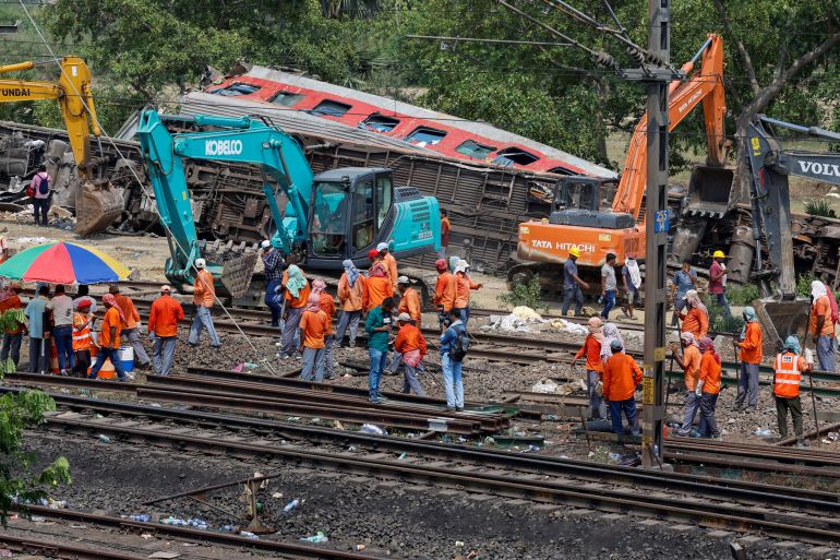 Heavy machinery remove damaged coaches from the railway tracks in Balasore