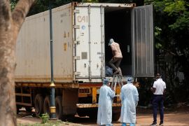 A man enters a deep freezer truck filled with bodies to try to identify a family member at a hospital in Bhubaneswar in the eastern Indian state of Odisha [Francis Mascarenhas/Reuters]