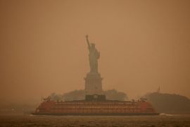 New York City&#39;s Statue of Liberty is covered in haze and smoke caused by wildfires north of the US in Canada. [Amr Alfiky/Reuters]
