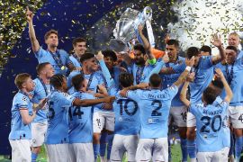 Manchester City's Ilkay Gundogan lifts the trophy as he celebrates with teammates after winning the Champions League. [REUTERS/Matthew Childs]