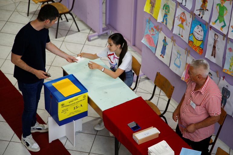A man casts his vote at a polling station during snap parliamentary in Montenegro