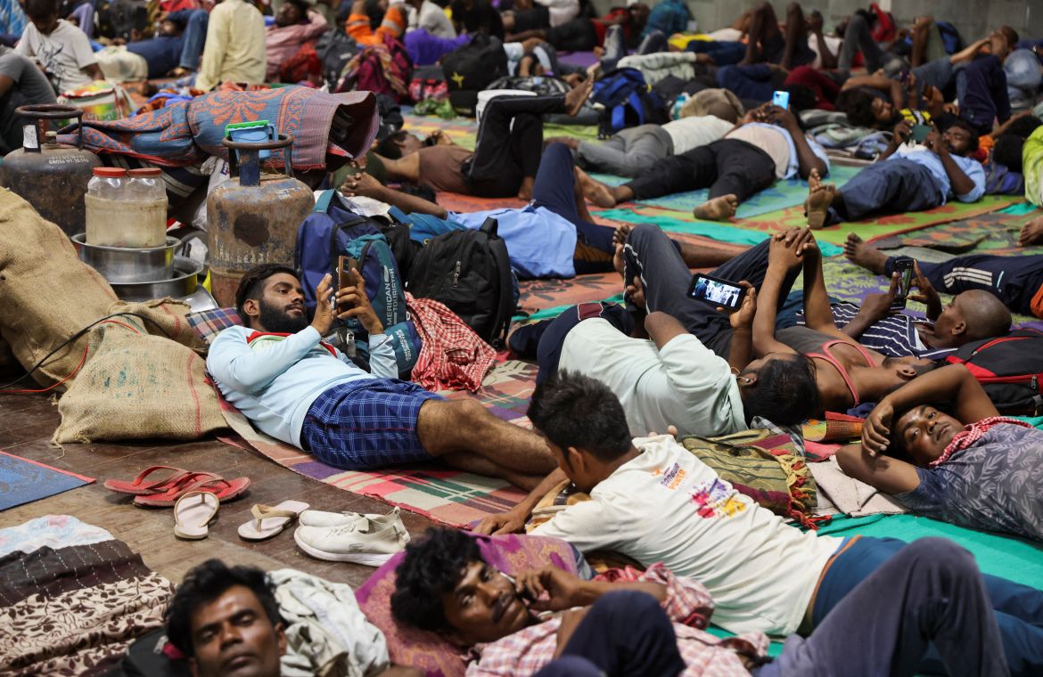 People evacuated from Kandla port lie inside a port authority multi-purpose hall converted into a shelter,