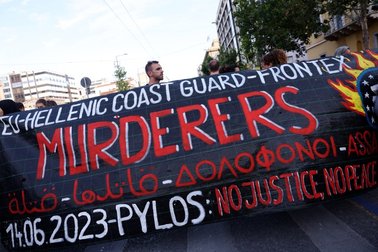 Protesters hold a banner during a demonstration