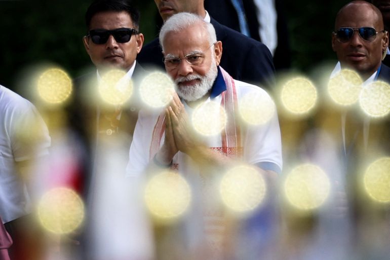 Indian PM Narendra Modi gestures as he arrives at an international yoga day event.
