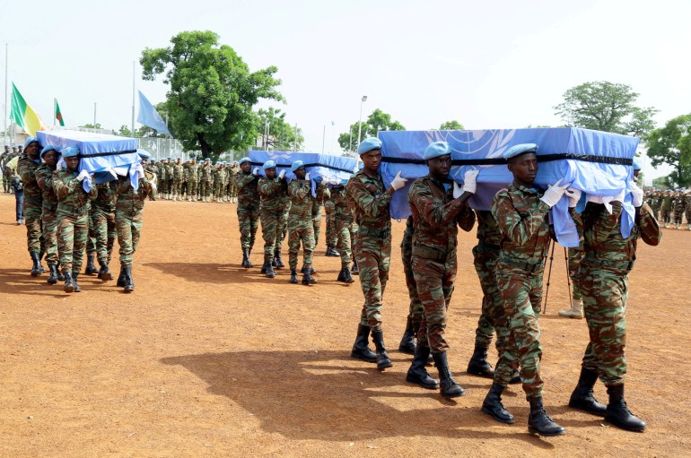 U.N. peacekeepers carry the coffins of the three United Nations soldiers from Bangladesh, who were killed by an explosive device in northern Mali on Sunday, during a ceremony at the MINUSMA base in Bamako, Mali 