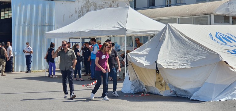 Aid workers outside the warehouse in Kalamata where surivors were being kept.