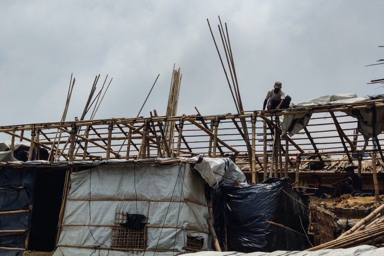 A Rohingya refugee fixing his shelter after Cyclone Mocha blew it away