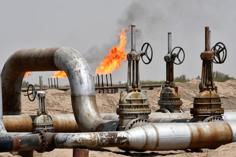 Pipelines and chimneys burning flames at the Nassiriya oil field in Iraq
