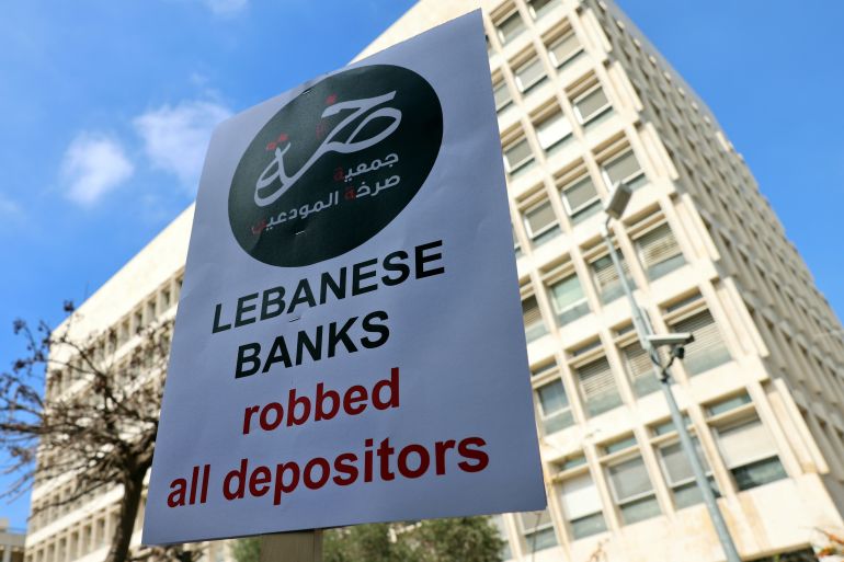 Demonstrators carry banners during a protest organised by "Depositors' Outcry" to ask for their deposits blocked in Lebanese banks