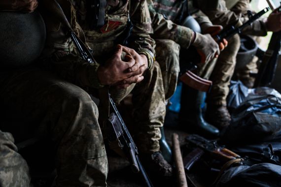 Ukrainian servicemen in the back of the military truck. Their faces are not shown.