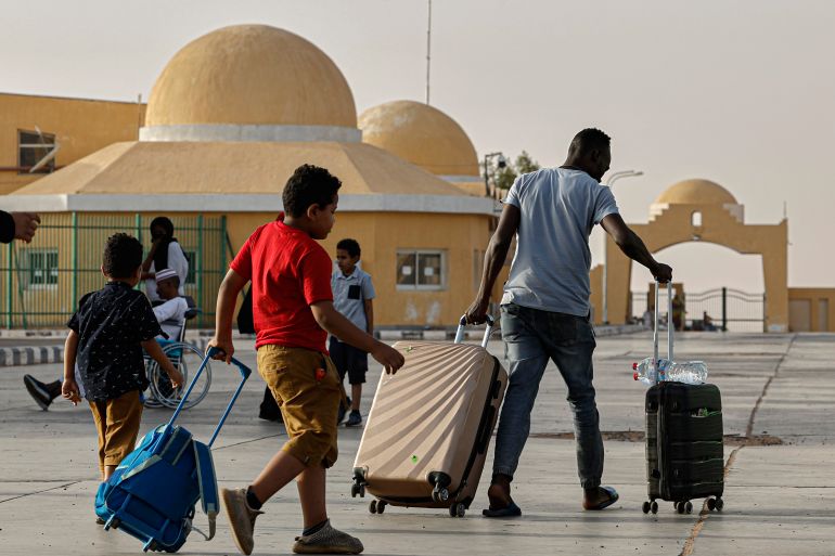 Passengers fleeing war-torn Sudan cross into Egypt through the Argeen Land Port on May 12, 2023.