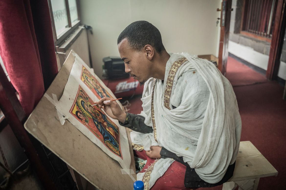 A Hamere Berhan initiative art student paints a piece of traditional biblical art on a parchment made of goat skin