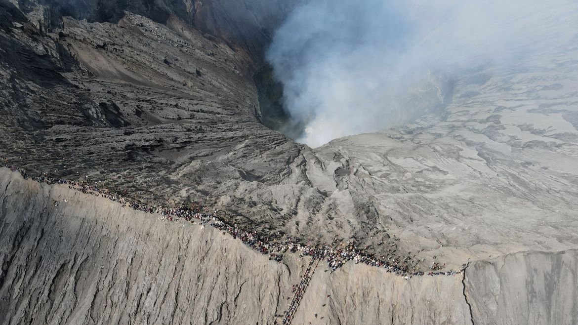 This aerial picture shows members of the Tengger sub-ethnic group gathering to present offerings at the crater's edge