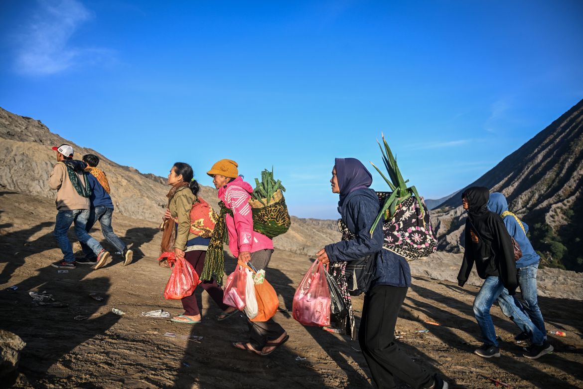 Members of the Tengger sub-ethnic group ascend the active Mount Bromo volcano