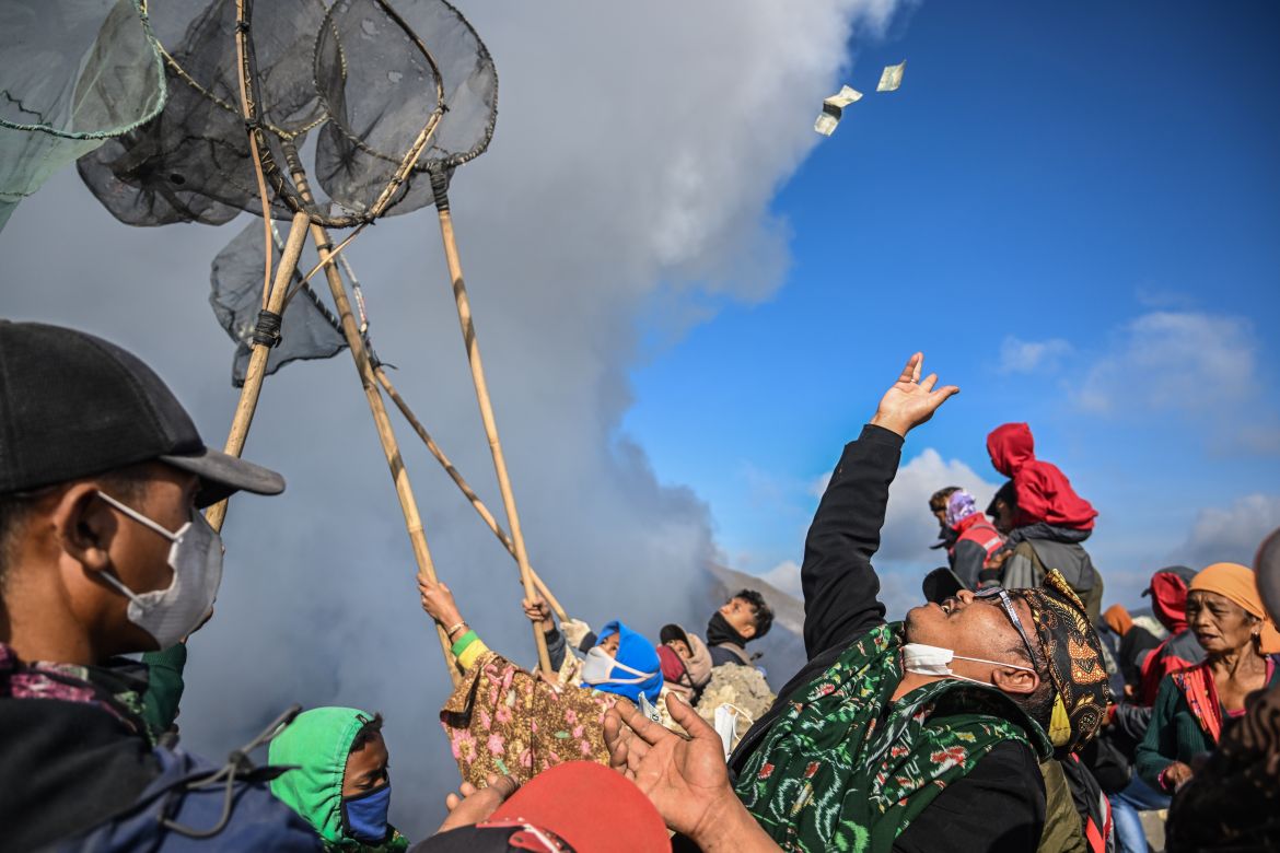 Members of the Tengger sub-ethnic group gather to present offerings at the crater's edge