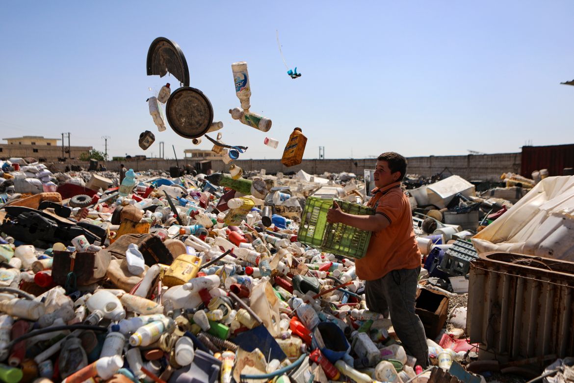 In this picture taken on June 1, 2023, a young boy works at a scrapyard where plastic junk gathered from dump sites is sorted for recycling