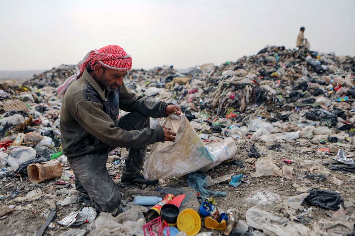 In this picture taken on June 3, 2023, Mohammed Behlal, 39, sifts through rubbish looking for plastic items to sell, at a dump site near the village of Hazreh in Syria's northwestern Idlib province.