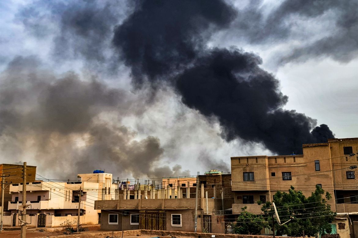 Smoke billows from a fire at a lumber warehouse in southern Khartoum [AFP]