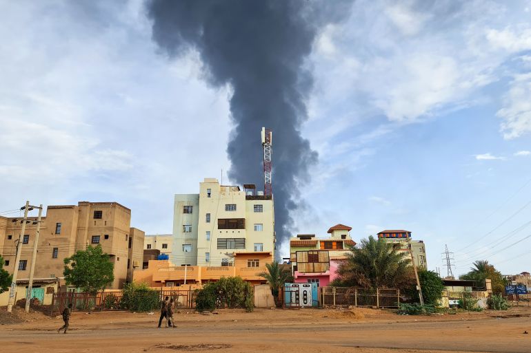 Black smoke billows behind buildings amid ongoing fighting in Khartoum