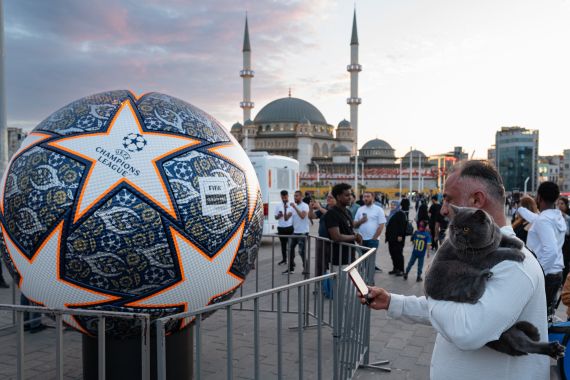 A man takes a picture of a giant replica of the Champions League soccer ball at Taksim Square on June 9, 2023 on the eve of the UEFA Champions League final between Inter Milan and Manchester City.
