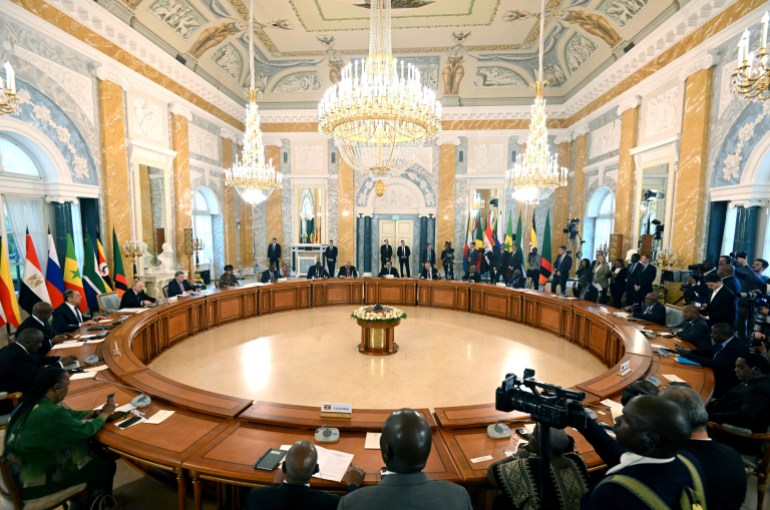 This handout photo taken by RIA Novosti on June 17, 2023 shows Russian President Vladimir Putin, left, with representatives of African leaders at the Konstantinovsky Palace in Strelna, outside St Petersburg group meeting