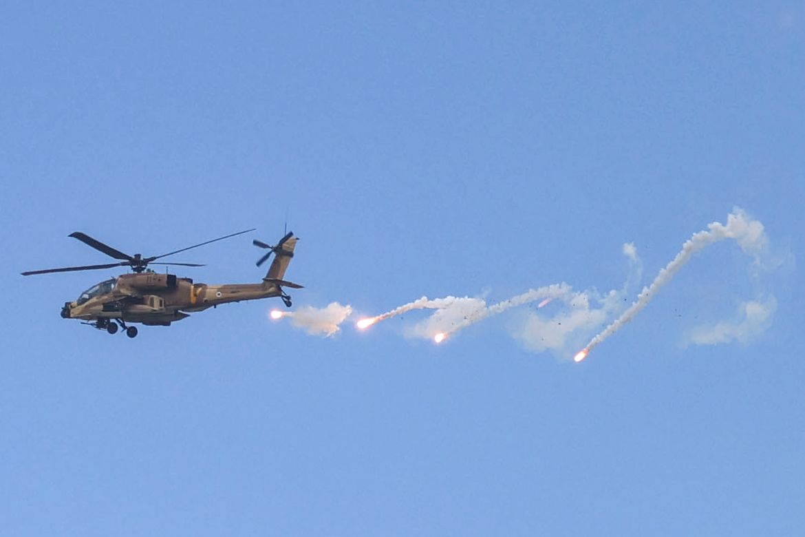 An Israeli Air Force AH-64 Apache attack helicopter releases a payload during an Israeli army raid in Jenin