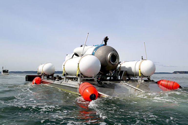 This undated image courtesy of OceanGate Expeditions, shows their Titan submersible being towed to a dive location in Everett, Washington. - Rescue teams expanded their search underwater on June 20, 2023, as they raced against time to find a Titan deep-diving tourist submersible that went missing near the wreck of the Titanic with five people on board and limited oxygen. All communication was lost with the 21-foot (6.5-meter) Titan craft during a descent June 18 to the Titanic, which sits at a depth of crushing pressure more than two miles