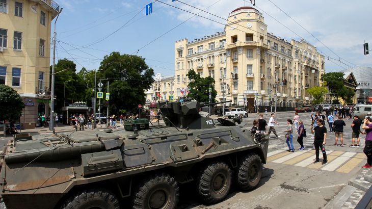 People walk past an armoured personnel carrier in the city of Rostov-on-Don