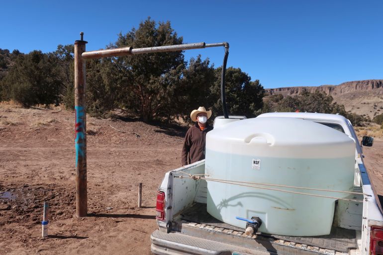 A man waits to fill a water drum on Navajo Nation
