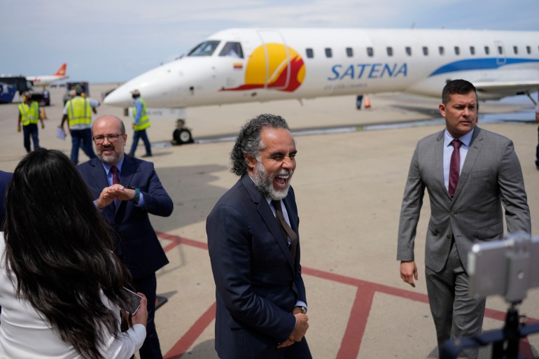 Colombian ambassador in Venezuela, smiles on the tarmac after a Satena airline plane arrived from Bogota, Colombia to Simon Bolivar International Airport in La Guaira, Venezuela, Wednesday, Nov. 9, 2022.