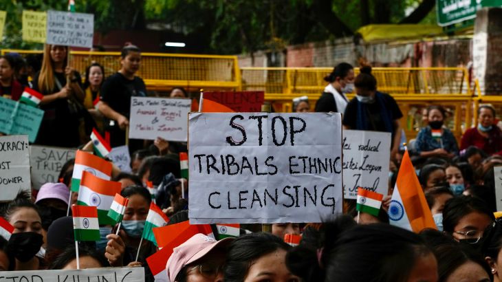 Members of the Kuki tribe protesting against the killing of tribals in their northeastern home state of Manipur, hold Indian flags and placards during a sit in protest in New Delhi, India, Monday, May 29, 2023. Manipur, which borders Myanmar, has been roiled by violence since 3 May after members of tribal groups clashed with a non-tribal group over demands of economic benefits and reservation status. More shootings and arson were reported Monday from the northeastern state, where dozens have been killed and more than 35,000 displaced following the worst ethnic clashes seen in decades. (AP Photo/Manish Swarup)