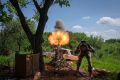 A Ukrainian soldier fires a mortar at Russian positions on the frontline near Bakhmut