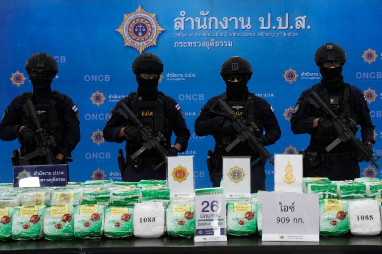 Police officers stand behind seized crystal methamphetamine during a news conference in Bangkok, Thailand, Thursday, June 1, 2023. The huge trade in illegal drugs originating from a small corner of Southeast Asia shows no signs of slowing down, the United Nations Office on Drugs and Crime warned Friday. (AP Photo/Sakchai Lalit)