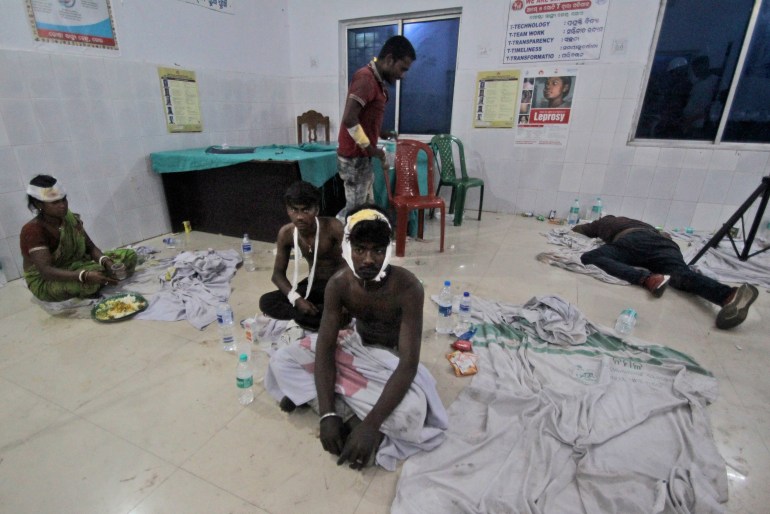 Injured passengers of trains accident sit at a local hospital in Balasore district