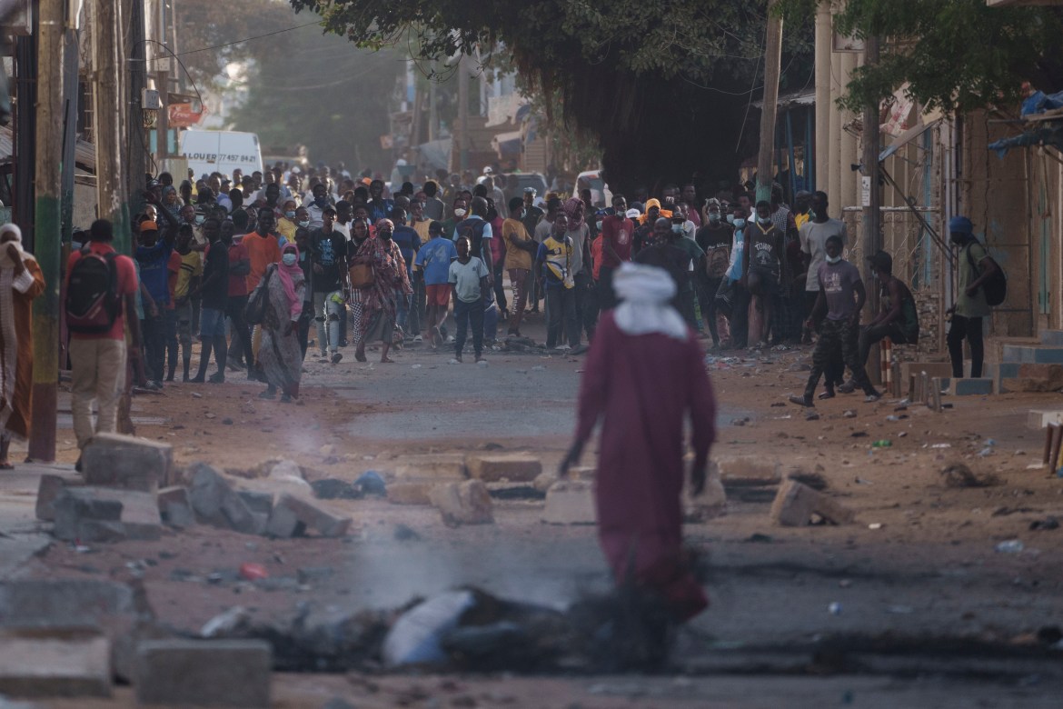 Demonstrators gather on a street during clashes with police at a neighborhood in Dakar