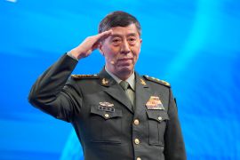 Chinese Defense Minister Li Shangfu salutes before delivering his speech at the Shangri-La dialogue
