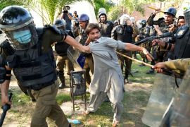 Police detain a supporter of former Pakistani Prime Minister Imran Khan in Lahore, Pakistan, on May 10, 2023 [File: KM Chaudary/AP Photo]