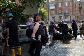Residents are evacuated from a flooded neighborhood in Kherson, Ukraine, after the Kakhovka dam was blown up [Roman Hrytsyna/AP Photo]