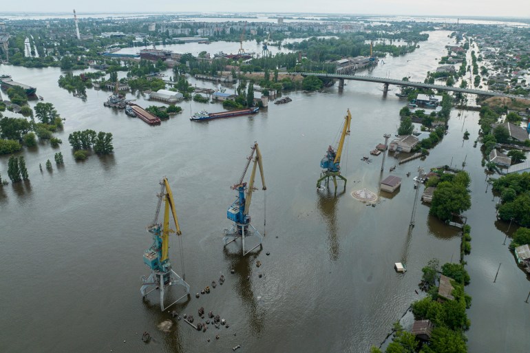 Streets and trade port are seen underwater and polluted by oil in the flooded Kherson
