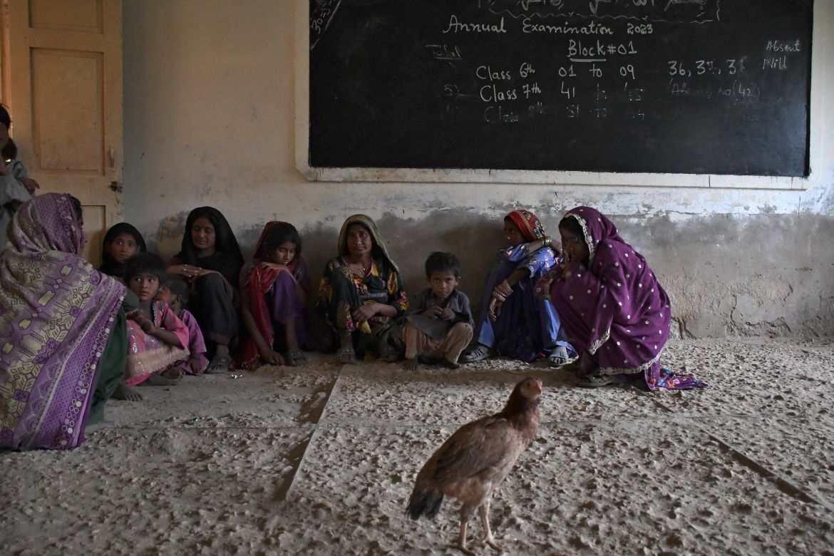 Women and children take shelter in a school building after fleeing from their villages