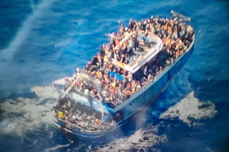 scores of people covering practically every free stretch of deck on a battered fishing boat that later capsized and sank off southern Greece