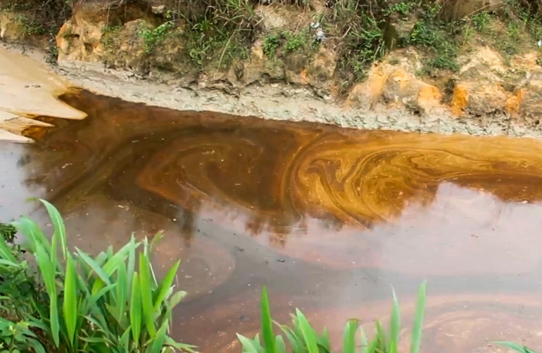 Oil spills contaminate the Okuku River in Ogoniland, Nigeria, June 16, 2023 (AP Photo)