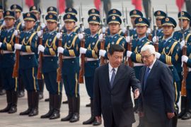 Chinese President Xi Jinping, front left, gestures to Palestinian President Mahmoud Abbas