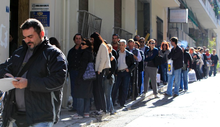 FILE- Unemployed Greeks wait in a long line at a state labor office to collect benefit checks, in Athens, in this file photo dated Monday, Oct. 24, 2011. Greece and Spain have the highest unemployment rates in the eurozone, with both countries also mired in a youth unemployment crisis, according to figures released by Eurostat, the EU's statistics office, Monday July 1, 2013, which reveals that unemployment across the 17 European Union countries that use the euro hit another all-time high in May 2013. (AP Photo/Thanassis Stavrakis, FILE)