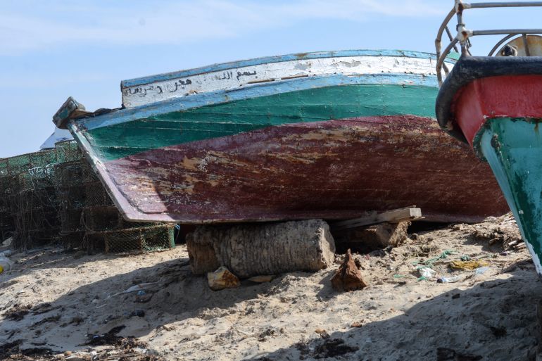 A fishing boat beached on a log