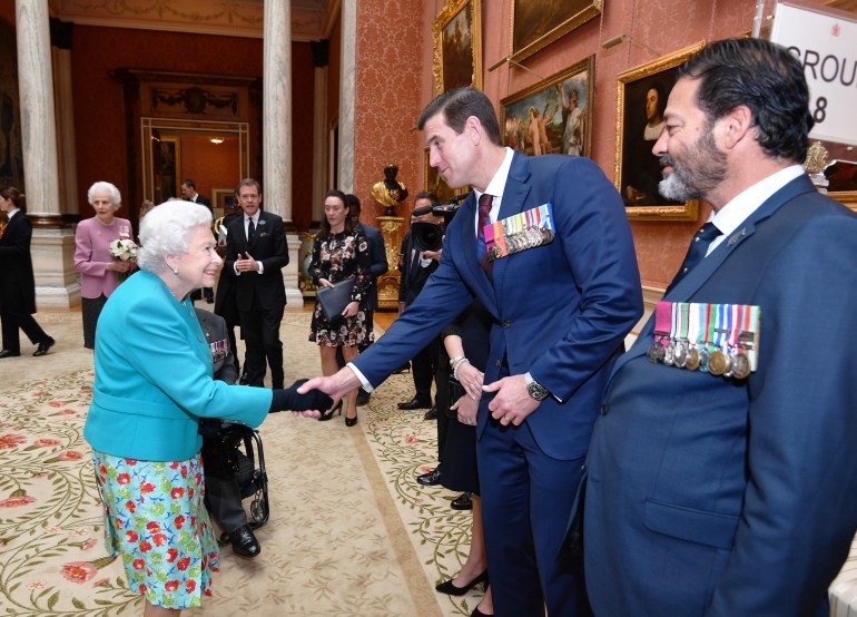 LONDON, UNITED KINGDOM - MAY 16: Queen Elizabeth II shakes hands with Mr Ben Roberts-Smith VC during a reception for the Victoria Cross and George Cross Association at in the Picture Gallery at Buckingham Palace on May 16, 2018 in London, England. (Photo by John Stillwell - Pool/Getty Images)